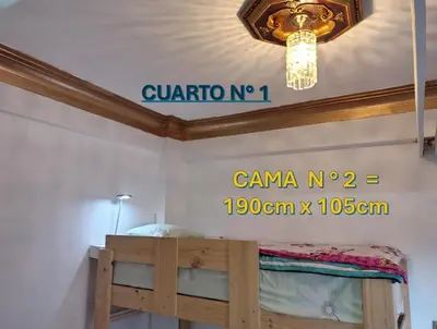 a bedroom with a bunk bed with a sign on the wall at Centro Historico Lima - Apartamento in Lima