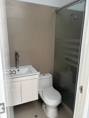a bathroom with a toilet and a sink and a shower at Beach house - Alto Bujama Condominium in Asia