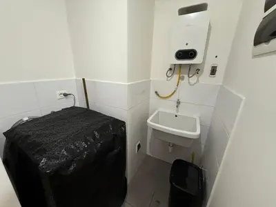 a small bathroom with a sink and a toilet at Modern XXL Apartment in San Miguel in Lima
