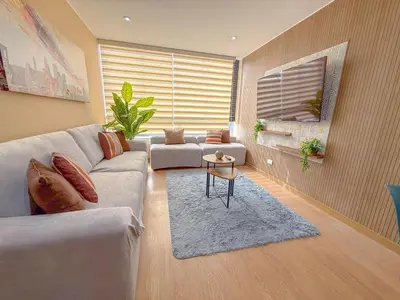 a living room with a couch and a table at Modern XXL Apartment in San Miguel in Lima