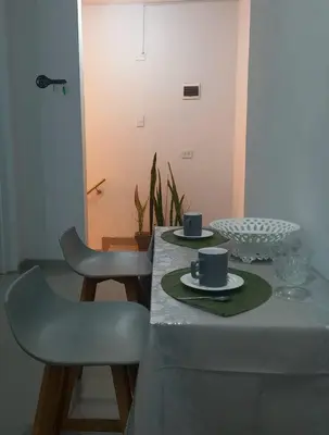 a table with two chairs and two cups on it at Habitacion Matrimonial con Baño Privado Entrada Independiente in Ica