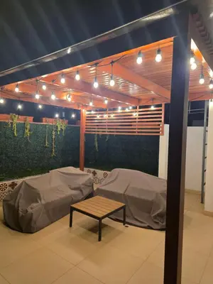 a room with two beds and a table and lights at Barranco sea in Lima