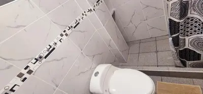 a white toilet in a bathroom with marble walls at Vistas increíbles desde San Blas 4 in Cusco