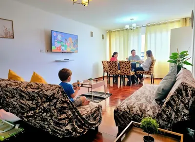 a group of people sitting in a living room at E Tourist Zone Wifi Pro 2 Smart TV 3B 1206 in Lima