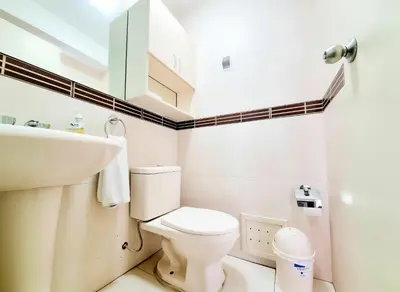 a bathroom with a white toilet and a sink at E Tourist Zone Wifi Pro 2 Smart TV 3B 1206 in Lima