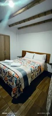 a bedroom with a bed with a blanket on it at Hospedaje Vientos in Paracas