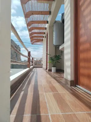an empty corridor of a building with a wooden ceiling at Hospedaje Vientos in Paracas