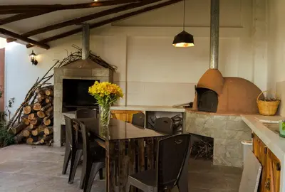 a kitchen with a table and a pizza oven at Casa Julia in Huayllabamba