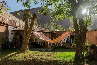 a hammock hanging in front of a house at Casa Julia in Huayllabamba
