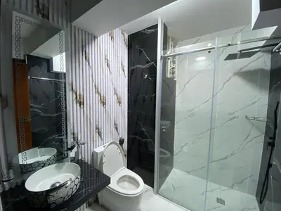 a bathroom with a toilet and a sink and a shower at Hotel Sonccollay in Huancayo