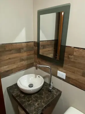 a bathroom with a sink and a mirror on a counter at Hotel Sonccollay in Huancayo