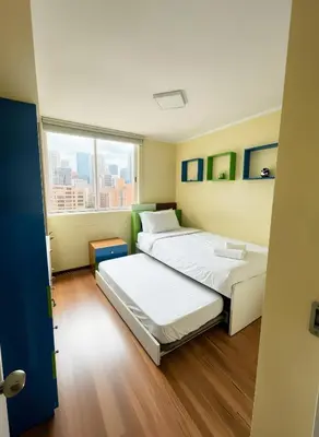 two beds in a room with a window at E Green View Parking Wifi Pro 4B 904 in Lima