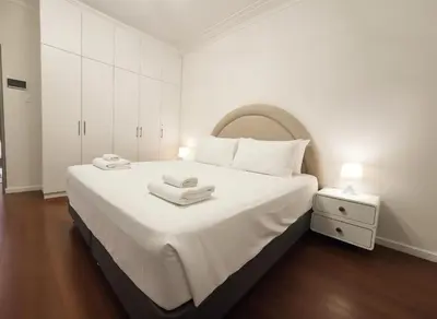 a white bedroom with a large bed with white cabinets at E LidiaHome Boutique Room Miraflores Wifi Pro 1B in Lima