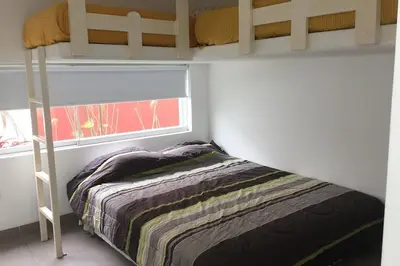 a small bedroom with a bunk bed and a window at Casa de playa 1era fila cala del mar in Salitre