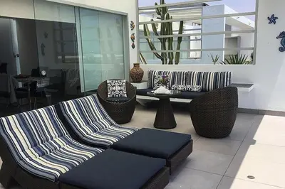 a living room with a couch and chairs and a table at Casa de playa 1era fila cala del mar in Salitre