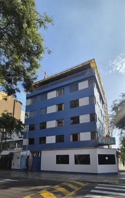 a blue and white building on a street at Hostal Winya in Lima