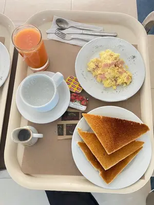 a tray with two plates of food and toast at Hostal Winya in Lima