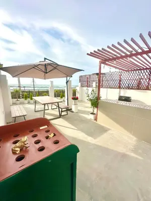 a patio with a table and an umbrella at Casa playa Paracas-Pisco in Pisco