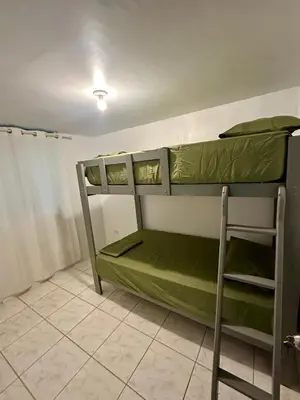 a room with two bunk beds in it at Casa playa Paracas-Pisco in Pisco