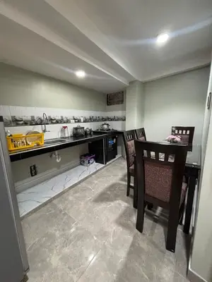 a kitchen with a table and chairs and a counter at Hogar Mesco in Cusco