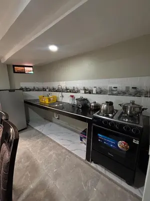 a kitchen with pots and pans on a stove at Hogar Mesco in Cusco