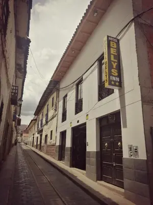 a building with a sign on the side of a street at Belys inn in Cusco
