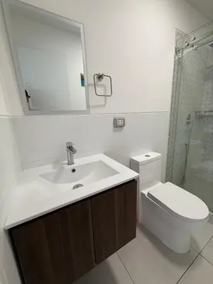 a bathroom with a sink and a toilet and a mirror at Departamento Vizuale in Lima