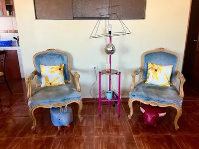 two blue chairs sitting in a room with a table at New colorful & artsy home, fam perfect, great wifi for working in Cusco