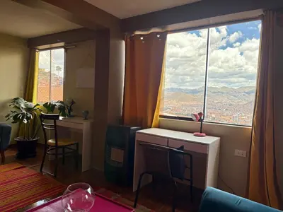 a living room with a large window with a view at New colorful & artsy home, fam perfect, great wifi for working in Cusco