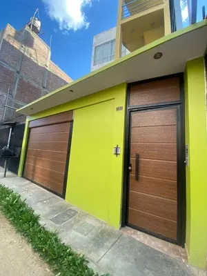 a pair of garage doors on a building at La casa de Betty in Huancayo