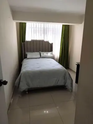 a bedroom with a large bed with a window at La casa de Betty in Huancayo