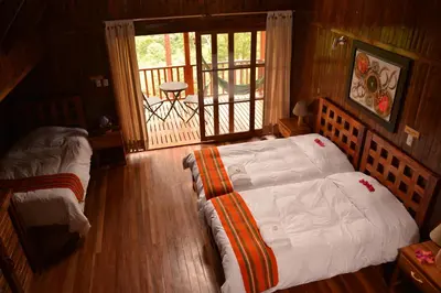 a bedroom with a large bed and a balcony at Altares de Oxapampa in Oxapampa