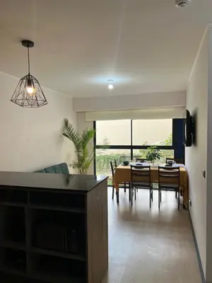 a kitchen and dining room with a table and chairs at Departamento 9 Personas San Isidro in Lima