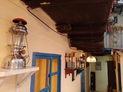 a room with a lantern on the wall and a door at Casa Margarita in Cusco