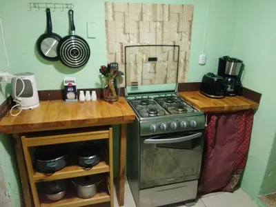 a kitchen with a stove and a wooden counter top at Casa Margarita in Cusco