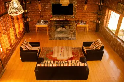a living room with a couch and a fireplace at Casa rústica Pumayalli in Urubamba
