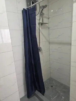 a shower with a blue shower curtain in a bathroom at Barranco blue sea in Lima