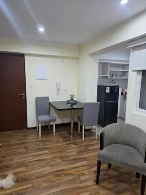 a room with a table and two chairs and a kitchen at Barranco blue sea in Lima