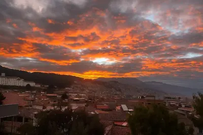 a view of a city at sunset at Apartamento Salkantay con vista al Cusco in Cusco