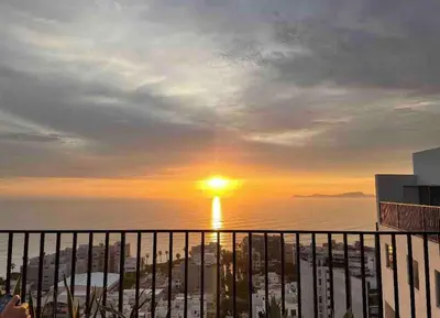 a view of the sunset from the balcony of a building at Lovely Ocean View Apartment 1512 in Lima