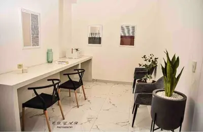 a room with a desk with chairs and a potted plant at Lovely Ocean View Apartment 1512 in Lima