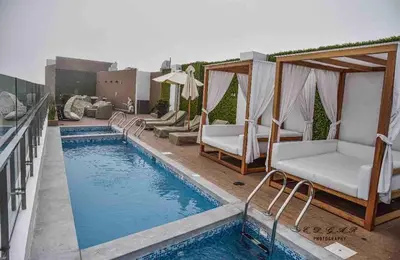 a pool with chaise lounge chairs and a swimming pool at Lovely Ocean View Apartment 1512 in Lima