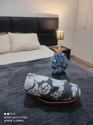 a bedroom with a bed with a pillow and a plant at Departamento frente al mar costa verde in Lima