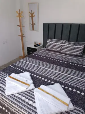 a bedroom with two beds with white towels on them at IN FRONT OF THE NEW AIRPORT Hospedaje A y C - Taxi Free - Airport - Apartment Includes breakfast in Lima