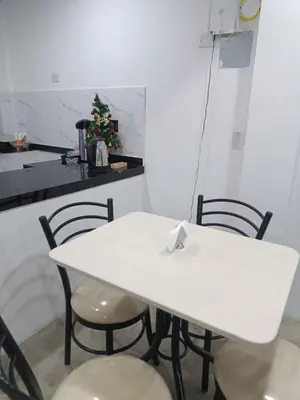 a white table and chairs in a kitchen at IN FRONT OF THE NEW AIRPORT Hospedaje A y C - Taxi Free - Airport - Apartment Includes breakfast in Lima