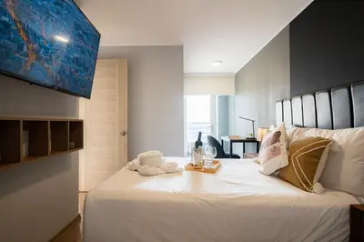 a bedroom with a large white bed with a tray on it at Centric Apartments by Vibrant in Lima