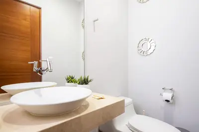 a bathroom with two sinks and a white toilet at Platino Apartments by Vibrant in Lima