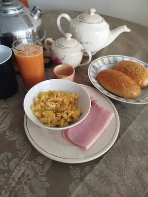 a table with a bowl of rice and a plate of food at Like a Home - Barranco in Lima