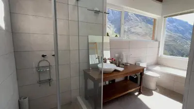 a bathroom with a shower and a sink and a tub at Urubamba Luxury Stay 