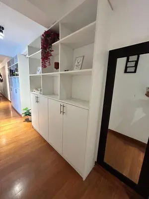 a room with white shelves and a hallway at Duplex penthouse in Miraflores with terrace in Lima